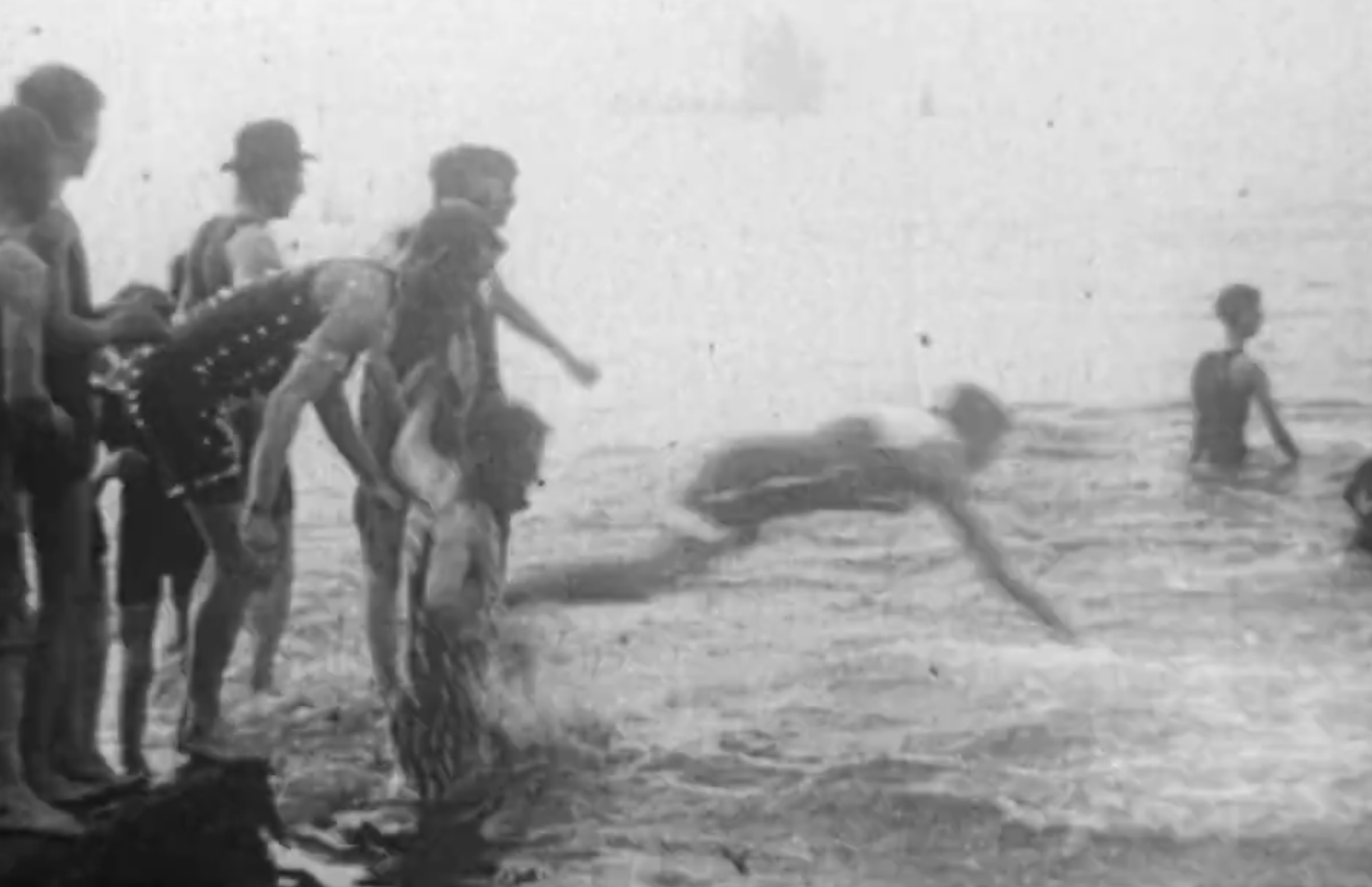 An archived black and white image of people jumping into Plymouth Sound at Tinside.