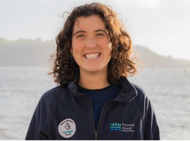 Coastal Ranger Lilah, with curly dark hair and a big smile.