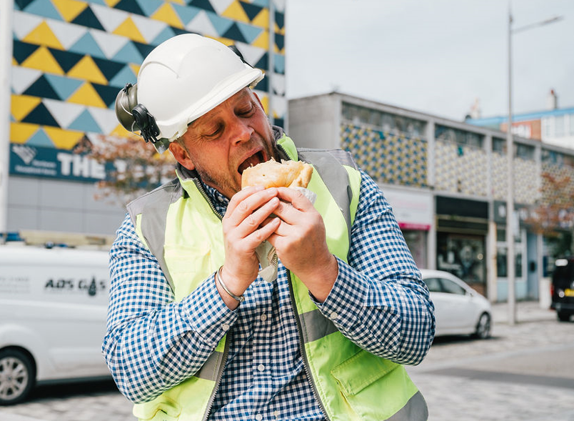 Man in PPE eating pasty Plymouth