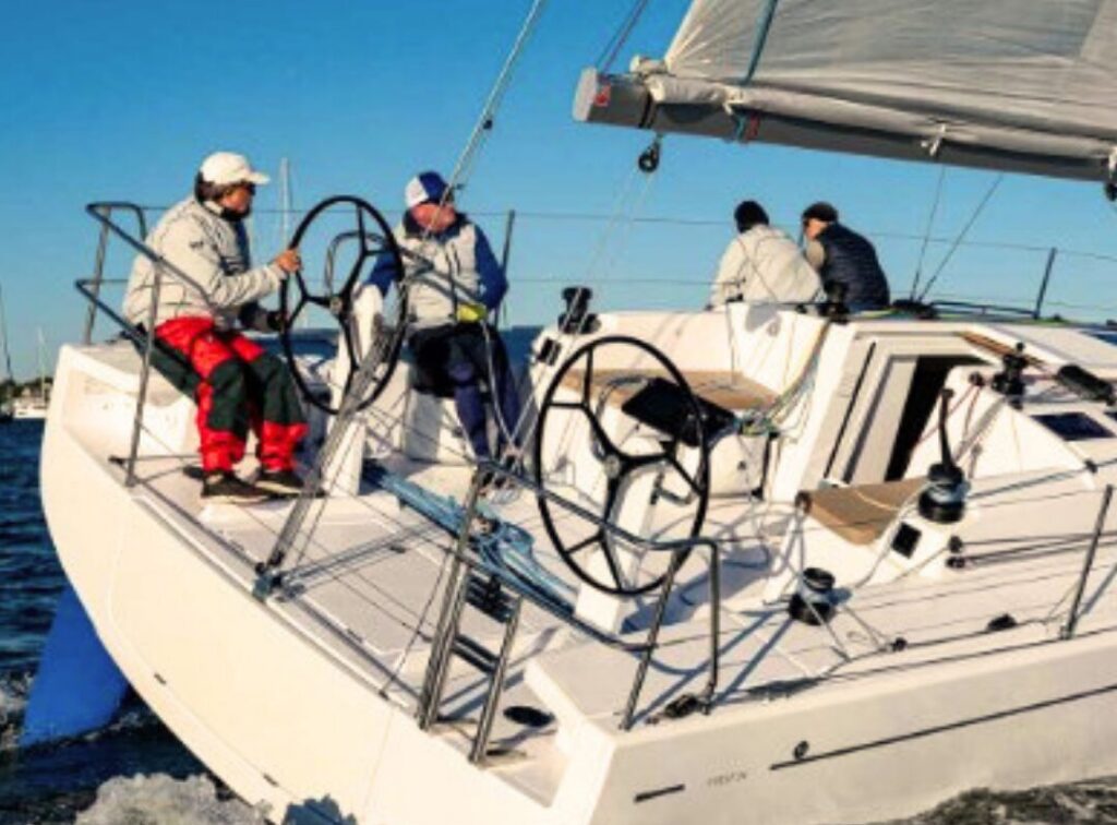 A crew on a sailing boat in Plymouth Sound.