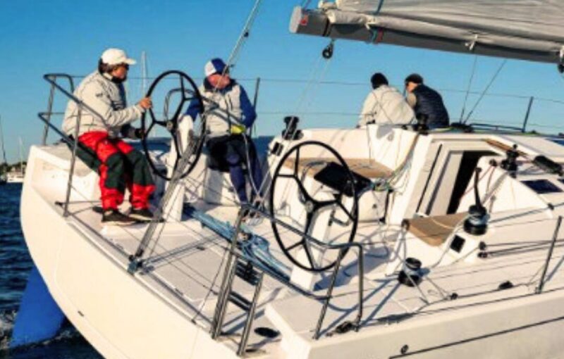 A crew on a sailing boat in Plymouth Sound.