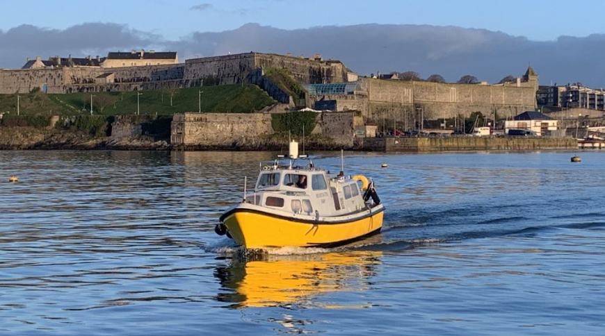 Mount Batten Ferry on the water which Plymouth Barbican in the background