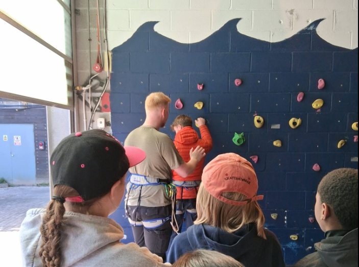 Blue Sparks - East End Development Trust - Man teaching young people how to indoor climb
